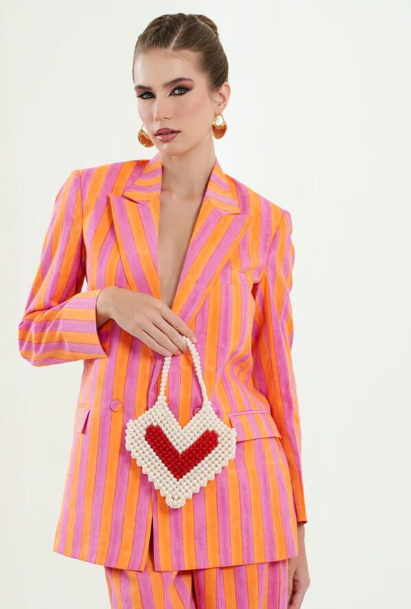 Model wearing the OrPink set and holding a heart shaped purse