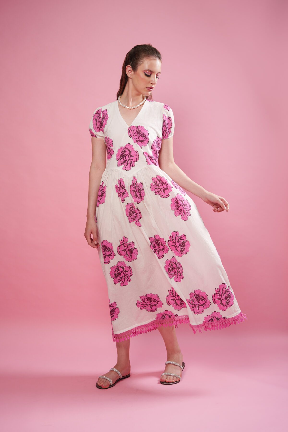 Rosina Dress frontside, and dress is flowing. model looking right