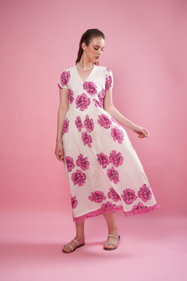 Rosina Dress frontside, and dress is flowing. model looking right