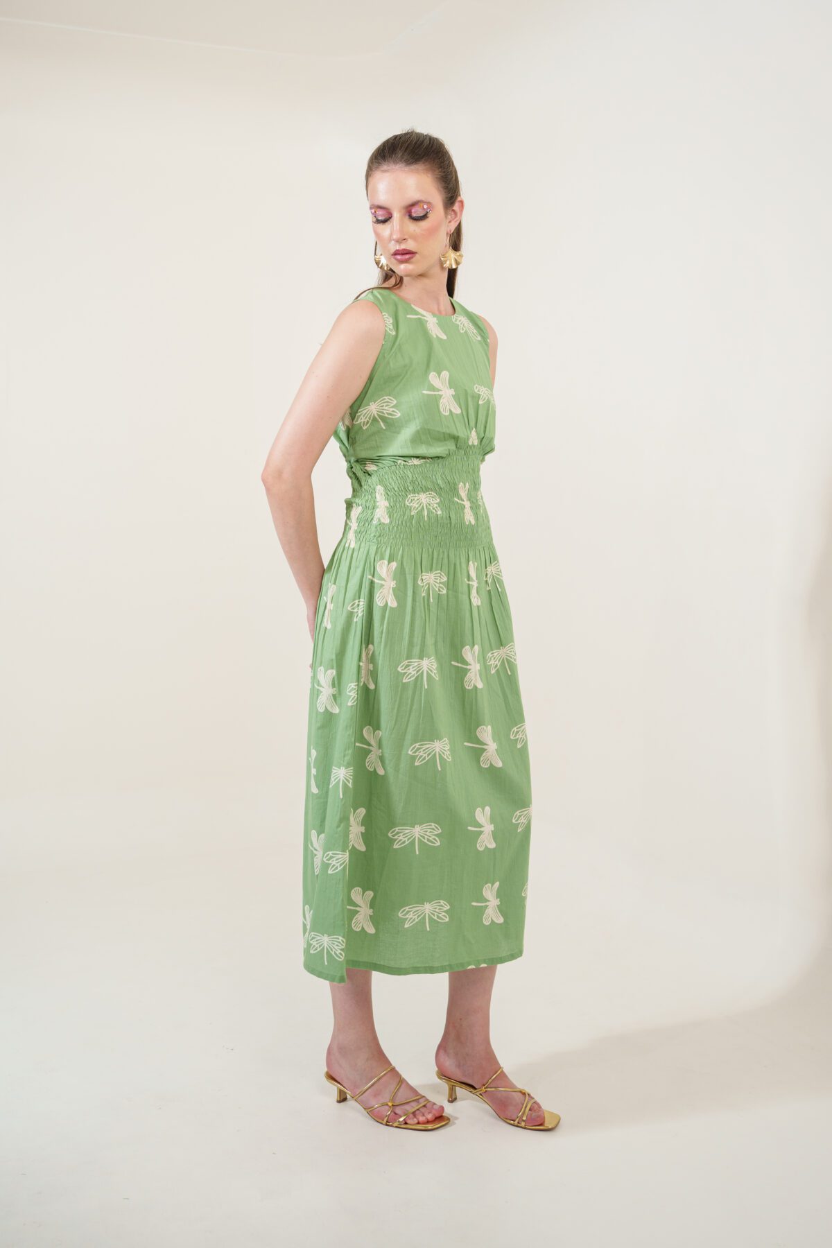 Firefly Dress leftside, with hands folded in the back